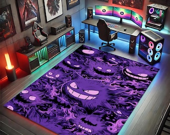 May include: A purple and black area rug featuring a repeating pattern of cartoon ghost characters. The rug is rectangular and placed in a gaming room setting, with a desk, computer, and wall art visible in the background.