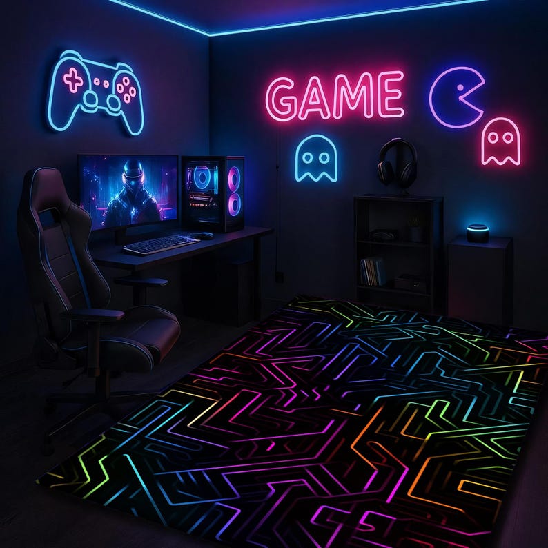 May include: A gaming room with neon lights. A neon blue controller and the word "GAME" in pink are on the wall. A black gaming chair sits in front of a desk with two monitors and a computer. A rug with a colorful circuit board design is on the floor.