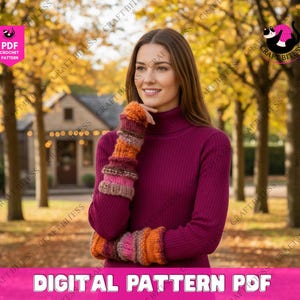 May include: A woman wearing a burgundy turtleneck sweater and striped arm warmers in shades of orange, pink, and brown. The image includes the text "DIGITAL PATTERN PDF". The background features fall foliage.