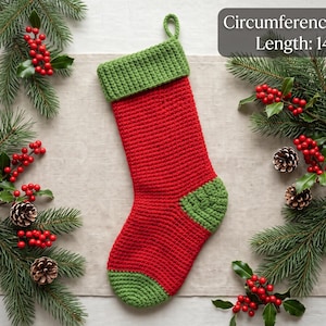 May include: A red and green crocheted Christmas stocking with a loop at the top for hanging. The stocking features a red body with a green cuff, heel, and toe. Text on the image states: Circumference: 10", Length: 14".