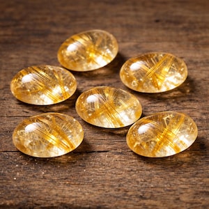 Cabochão de rutilo dourado AAA+ | Gema oval natural, base plana calibrada