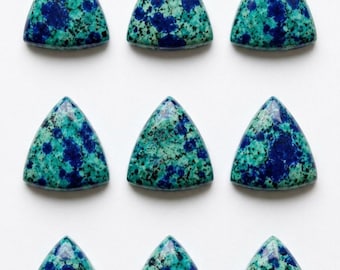 May include: Nine polished triangle-shaped cabochons arranged in a three-by-three grid. Each stone features a mottled pattern of vibrant royal blue, deep teal, and dark black speckles with a smooth, glossy surface finish and rounded edges.