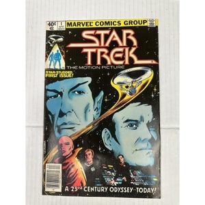 May include: A vintage Star Trek comic book cover. The cover features portraits of characters, the Star Trek logo, and the text "The Motion Picture." The comic is labeled as the first issue.