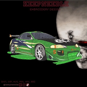 May include: An embroidered design featuring a green and black sports car with the number 5-1 on the front. The design includes the text "KEEPNEEDLE EMBROIDERY DESIGN" at the top and a skull on the right side.