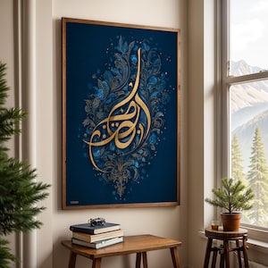 May include: A framed artwork with gold Arabic calligraphy on a dark blue backdrop, adorned with blue and gold floral and leaf motifs. The artwork hangs in a room with a wooden table and a window offering a view of mountains and trees.