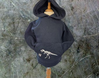 Footy Rex: Sudadera con capucha de fútbol T-Rex que brilla en la oscuridad para niños; sudadera con esqueleto de dinosaurio bordado