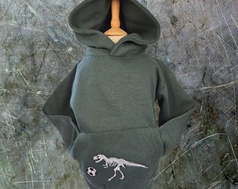 Footy Rex: Sudadera con capucha de fútbol T-Rex que brilla en la oscuridad para niños; sudadera con esqueleto de dinosaurio bordado