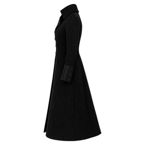 May include: A long, black coat with a high collar and button details. The coat features a subtle, textured pattern and flared skirt. The sleeves have decorative cuffs with button accents. The coat is designed for a formal or vintage aesthetic.