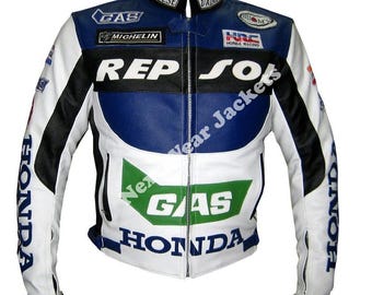 May include: A white, blue, and black leather motorcycle jacket with multiple sponsor logos. The jacket features the Honda, Repsol, and Gas logos. The sleeves have the word "HONDA" printed on them. The jacket has a zippered front and a stand-up collar.