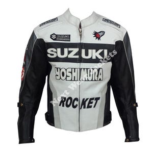 May include: A white and black motorcycle jacket with the Suzuki and Yoshimura logos. The jacket has a zip-up front, black sleeves, and the word "ROCKET" printed on the front. The jacket also has the Dunlop logo.