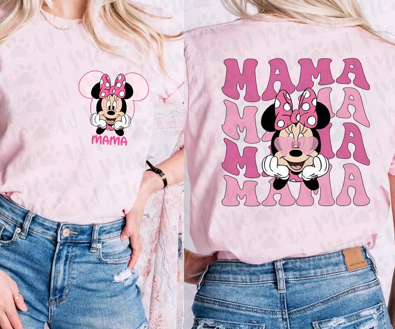 May include: Pink t-shirt featuring a Minnie Mouse graphic with a pink bow and the word "MAMA". The back of the shirt has a repeating "MAMA" design with Minnie Mouse wearing heart-shaped sunglasses.