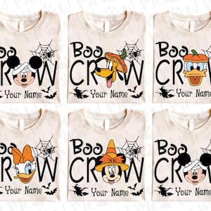 May include: Six cream-colored t-shirts with Halloween-themed designs. Each shirt features the text "Boo Crew" with a different Disney character in a Halloween costume. The text "Your Name" is below the design.
