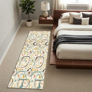 May include: A rectangular runner rug featuring a cream background with a repeating mid-century atomic pattern in shades of teal, mustard yellow, dark brown, and orange. The design includes stylized starbursts, orbital lines, and circular motifs.