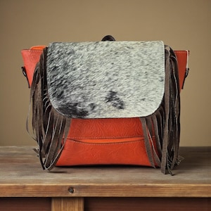 Boho Convertible Cowhide Leather Backpack Purse with Hair-On Hide and Fringe | Mandarin Orange | Snap & Zipper Closure