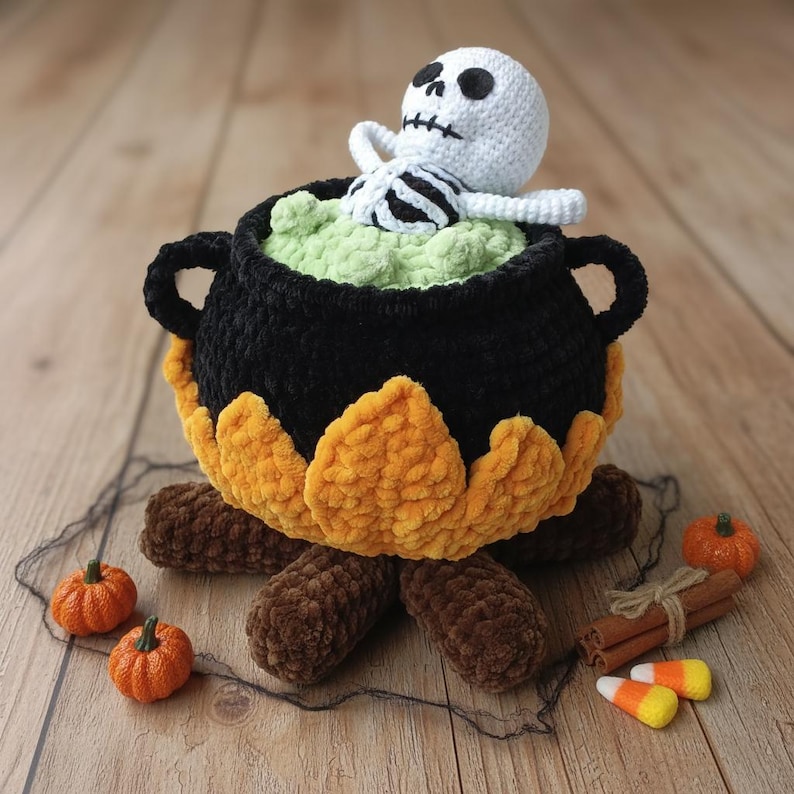 Crochet Halloween amigurumi pattern featuring a black plush cauldron with yellow flames, a bubbling green potion, and a cute white skeleton sitting inside. Perfect for spooky home décor, Halloween party centerpiece, or a handmade gift. This detailed crochet pattern is ideal for amigurumi lovers and includes step-by-step instructions. Great project for Halloween crafters looking for unique and fun holiday decorations.