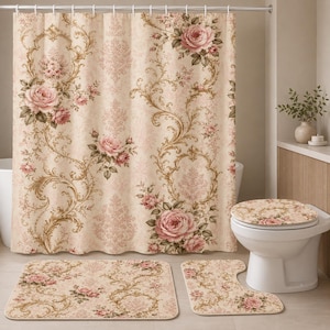 May include: A bathroom set featuring a shower curtain, a rectangular floor mat, a contour rug, and a toilet seat cover. Each piece displays a cream background with a repeating damask pattern in gold and large pink rose floral arrangements.