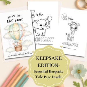 May include: A collection of baby keepsake books with illustrations of an elephant, giraffe, and a hot air balloon. The books are white with black outlines and pastel colors. The text "BABY'S FIRST ABC BOOK" and "KEEPSAKE EDITION" are visible.