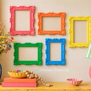 May include: Five ornate, empty picture frames in pink, orange, yellow, green, and blue are arranged on a wall. Below them, a blue and white striped vase with flowers, a yellow bowl with beads, stacked books, and a lamp are visible. Text reads Printable Palette Joy.