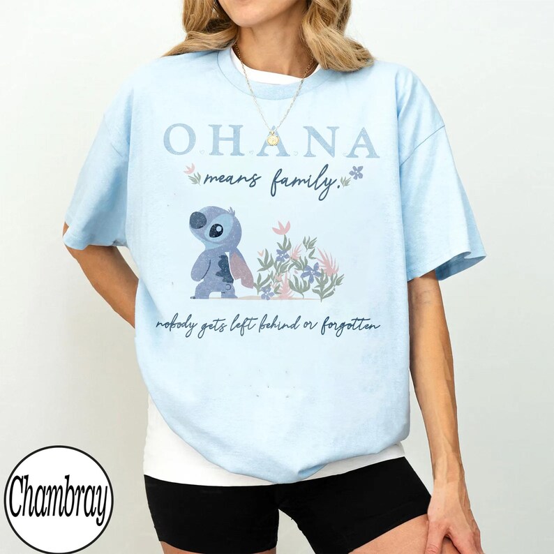 May include: Light blue t-shirt with the text "OHANA means family." and a cartoon character illustration. The shirt also has the phrase "nobody gets left behind or forgotten."