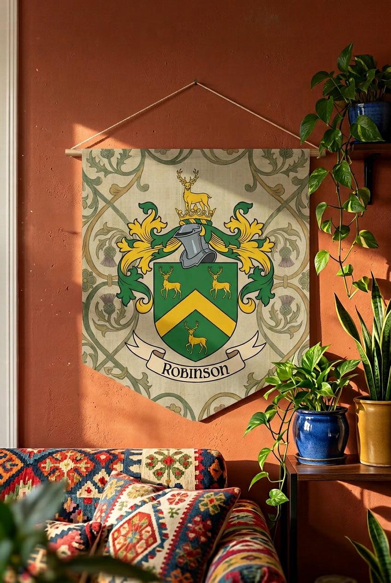 May include: A decorative wall hanging featuring a family crest with the name "Robinson" on a banner. The crest includes a shield with deer and a yellow chevron, set against a patterned background. The banner is suspended from a wooden rod.