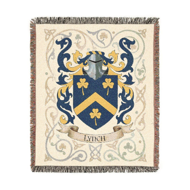 May include: Cream-colored throw blanket with a family crest design. The crest features a blue shield with gold chevron and shamrocks, a silver helmet, and blue and gold decorative elements. The word "Lynch" is on a banner.