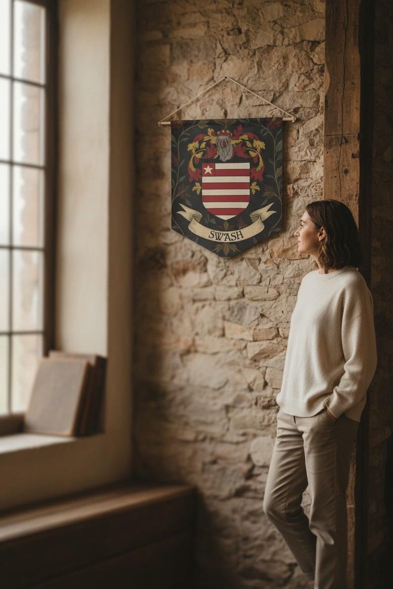 May include: A decorative wall banner featuring a crest design with red and white stripes, a star, and floral accents. The banner has the word "SWASH" on a scroll. The banner is hanging on a stone wall.