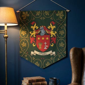 May include: A green banner with a family crest, featuring a shield with stars, wheat, and a cross. The banner has a decorative border with gold accents and the name "O'Friel" on a white banner. It hangs on a wall with a lamp and books.