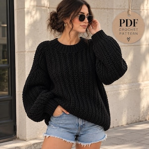 May include: A black long-sleeve jumper with a chunky ribbed knit texture, a crew neckline, and dropped shoulders. A circular tan tag in the upper right corner features the black text PDF CROCHET PATTERN with a small heart symbol below it.