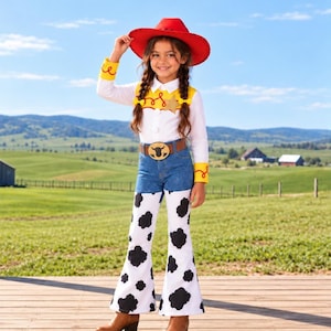May include: A cowgirl costume featuring a red cowboy hat, a white long-sleeve shirt with yellow cuffs and a yellow vest overlay with a gold star badge, and blue denim pants with white and black cow-print flared bottoms and a brown belt.