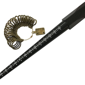 May include: A black ring sizer tool with white measurement markings and a set of olive-green ring sizer gauges. The ring sizer tool is long and tapered, with a rounded end. The ring sizer gauges are attached to a metal plate.