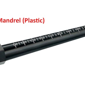 May include: A black plastic ring mandrel with white measurement markings. The mandrel is tapered and has a rectangular base. The text "Mandrel (Plastic)" is in red above the mandrel.