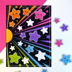 May include: A sheet of colorful star stickers with smiling faces. The stickers are in various colors, including orange, pink, purple, blue, and green, with white stitching. The background is black with radiating lines. Additional loose star stickers are scattered around.
