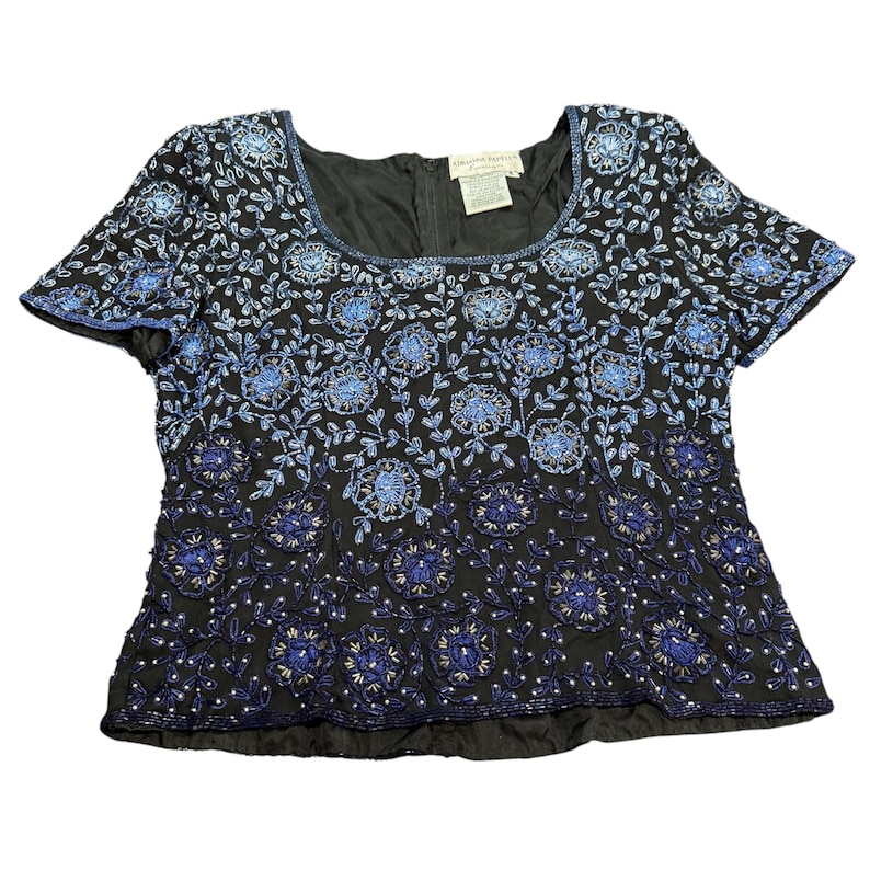 May include: Black short-sleeved top with a square neckline, adorned with intricate blue floral and leaf embroidery. The design features a gradient effect, transitioning from dark to light blue. The top has a zipper closure in the back.