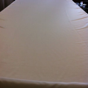 May include: A plain white tablecloth, perfect for a simple and elegant table setting.