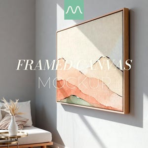 Puede incluir: Maqueta de lienzo enmarcado con una pintura de paisaje en acuarela con tonos melocotón, beige y verde. La obra de arte se muestra en un marco de madera clara. Las palabras "FRAMED CANVAS MOCKUP" están escritas en blanco en la imagen.