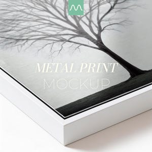 May include: A rectangular metal print featuring a black and white photograph of a leafless tree against a bright sky. The print is encased in a clean white frame and displays the centered white text METAL PRINT MOCKUP on the surface.