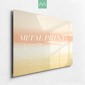 May include: A rectangular metal print featuring a soft, horizontal gradient of peach, cream, and pale yellow colours. The surface is glossy and reflective, displaying the white text METAL PRINT MOCKUP centred across the middle of the artwork.
