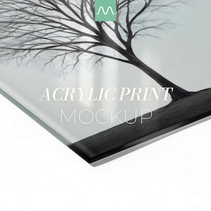 May include: A glossy acrylic print featuring a black and white photograph of a leafless tree against a light background. The text ACRYLIC PRINT MOCKUP is centered on the surface. A small green logo with a white M is visible at the top center.
