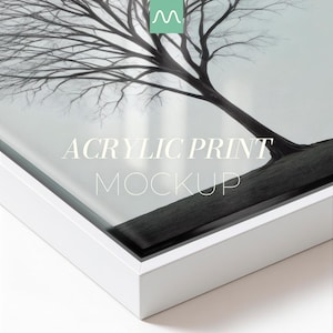 May include: An acrylic print mockup featuring a black and white image of a leafless tree with thin branches. The print is encased in a clean white frame. The text ACRYLIC PRINT MOCKUP is centred on the surface of the glossy acrylic panel.