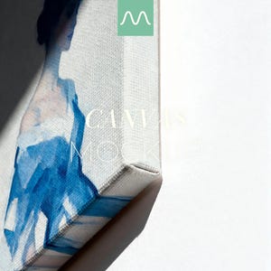 May include: A rectangular canvas print featuring a blue watercolour-style abstract figure. The canvas is wrapped around a wooden frame, showing a side profile view. The text "CANVAS MOCKUP" is printed in white across the centre of the canvas surface.