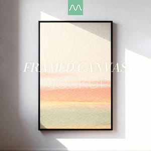 May include: A vertical rectangular framed canvas featuring an abstract watercolor painting with soft horizontal bands of cream, peach, and pale green. The text FRAMED CANVAS MOCKUP is centered in white over the artwork, which is enclosed in a thin black frame.