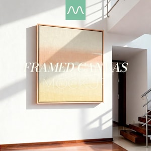 May include: A framed canvas mockup with a gradient of colors, including peach, yellow, and beige, hangs on a white wall. The text "FRAMED CANVAS MOCKUP" is overlaid on the canvas. The room has a modern design with wooden floors.