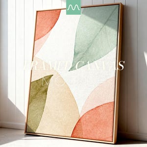Könnte beinhalten: Eine rechteckige gerahmte Leinwand mit einem abstrakten Aquarelldesign aus überlappenden Formen in gedeckten Tönen von Salbeigrün, Terrakotta-Orange und sanftem Beige auf weißem Grund. Der Holzrahmen hat ein helles, natürliches Finish.