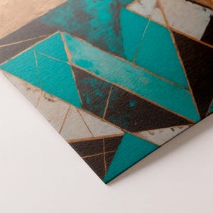 May include: Abstract geometric art print featuring teal, black, gray, and gold angular shapes. The artwork has a textured appearance and a modern aesthetic. The design incorporates triangles and other geometric forms.