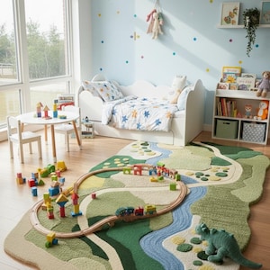 May include: A child's playroom with a landscape rug and a wooden train set. The room features a white bed with star-patterned bedding, a small table and chairs, and a bookshelf with books and toys. The walls are light blue with colourful polka dots.