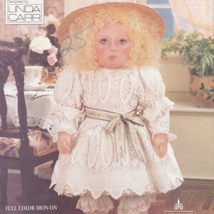 May include: A doll pattern for a girl doll wearing a white lace dress with a yellow sash, a straw hat, and white shoes. The pattern is from Vogue Craft and is designed by Linda Carr. The pattern number is 8240 and is one size.