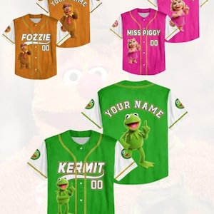 May include: Baseball jerseys in orange, pink, and green, featuring characters Fozzie Bear, Miss Piggy, and Kermit the Frog. Each jersey has a character image, name, and the number "00". The sleeves are white with character-themed accents. Text on the image reads "Custom Any Requests" and "Kid/Youth/Adult Baseball Jersey".