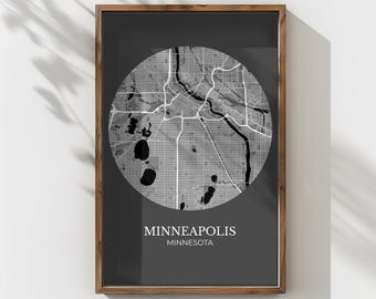 May include: Framed print featuring a grayscale map of Minneapolis, Minnesota, within a circular design. The city map is detailed with roads, waterways, and parks. The print is set against a dark gray background, with the city name and state below.