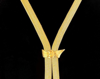 Collar bolo Boucher vintage de los años 50 en tono dorado, firmado y numerado.