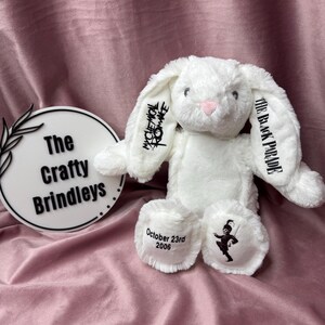May include: A white plush bunny with black text on the ears reading "My Chemical Romance" and "The Black Parade." The bunny has a pink nose and the date "October 23rd 2006" embroidered on one foot. A black and white illustration is on the other foot.
